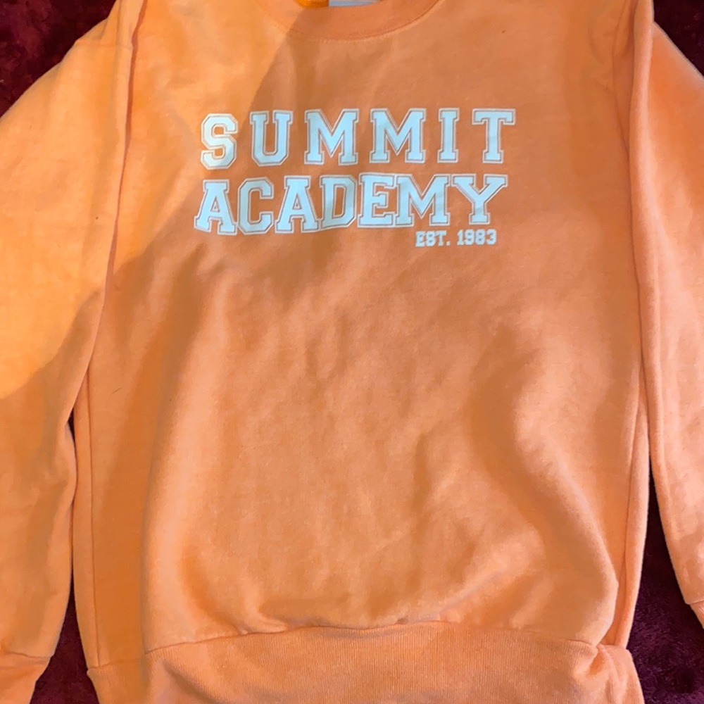 Light orange sweater.